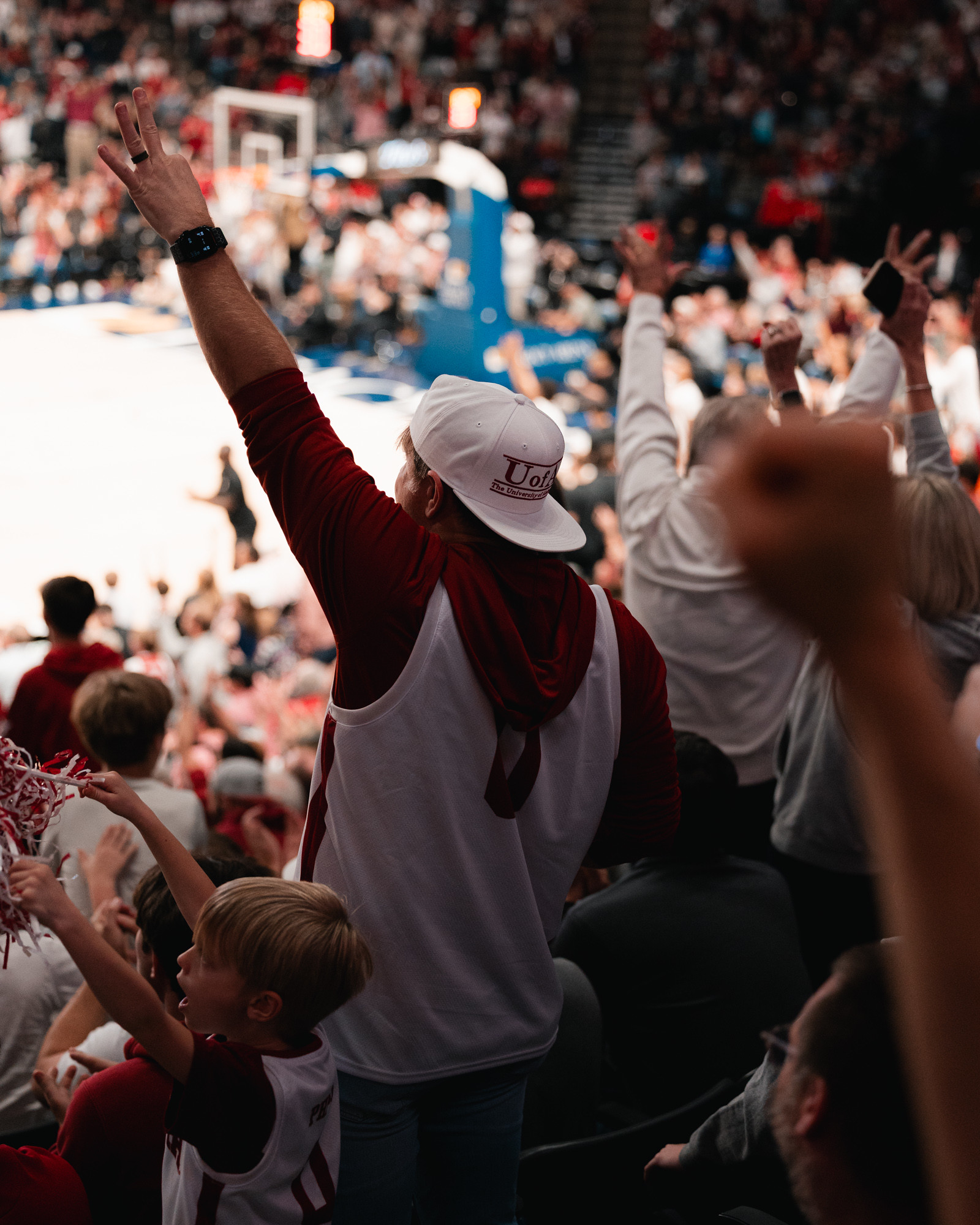 Alabama fans in crimson filling the stands at Legacy Arena